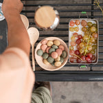 Child's stirring wooden counters inside a wooden bowl with the Grapat yummy set