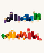 Grapat Lo wooden toy play set. A set that consists of cylinder and tubes than can be slotted in or on top of each other. These wooden toys are part of a wide range of open ended toys available at Babipur.