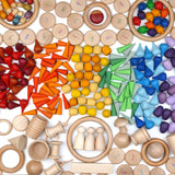 A variety of natural and coloured handcrafted Grapat wooden loose pieces laid in a decorative flatlay