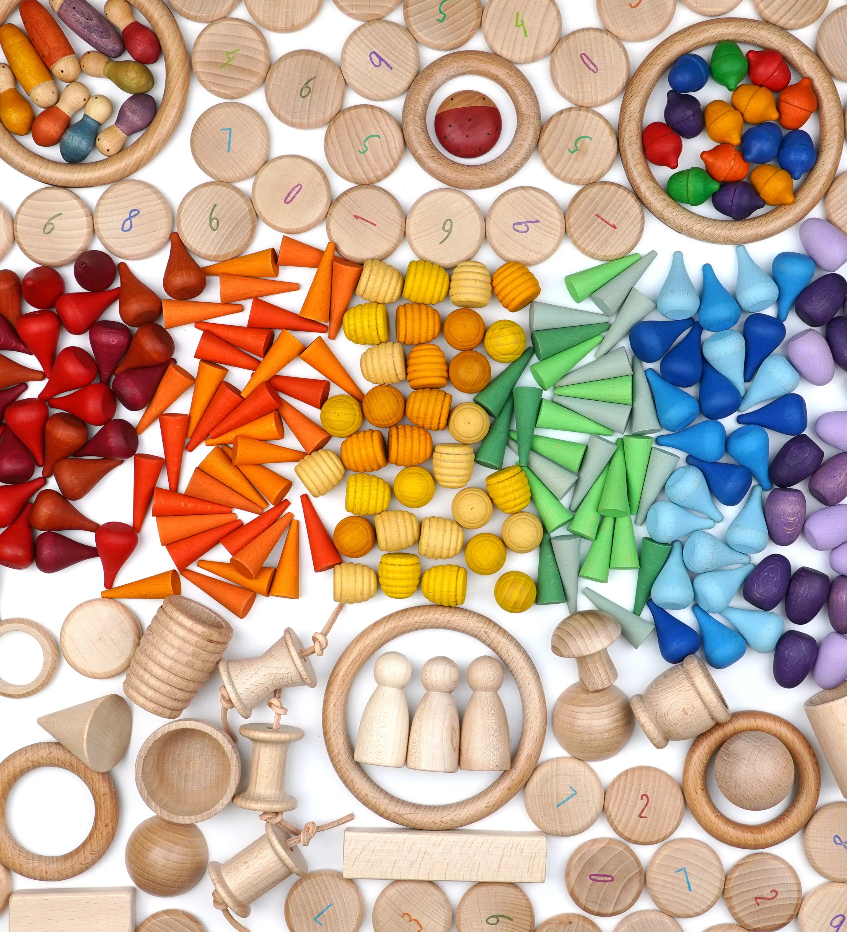 A variety of natural and coloured handcrafted Grapat wooden loose pieces laid in a decorative flatlay