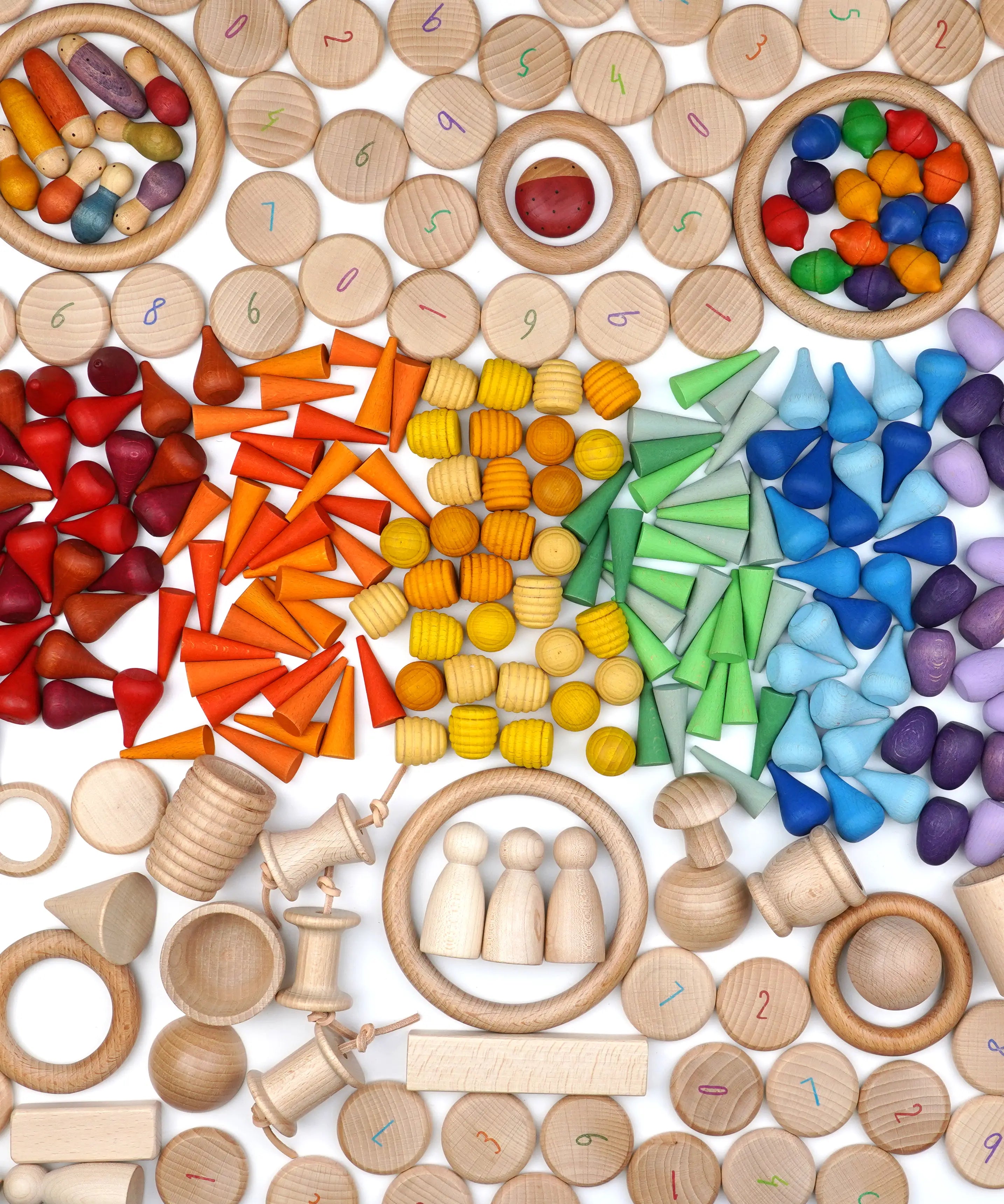 A variety of natural and coloured handcrafted Grapat wooden loose pieces laid in a decorative flatlay