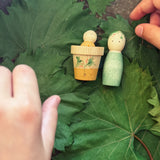 Child's hand playing with the Grapat Lucky Lucky mystery toy box number 12  little sprouts set of wooden toys. 