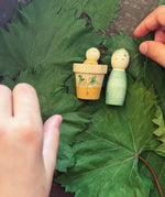 Child's hand playing with the Grapat Lucky Lucky mystery toy box number 12  little sprouts set of wooden toys. 