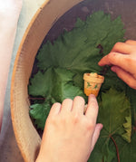 Child's hand playing with the Grapat Lucky Lucky mystery toy box number 12  little sprouts set of wooden toys. 