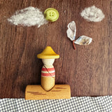 Grapat Lucky Lucky mystery toy box number 14 the fisherman set of wooden toys placed in a flatlay style small world play scene. 
