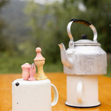 A outdoor picnic setting showing the 3 outdoor inspired wooden peg dolls and pieces from the Grapat lucky lucky boxes. Features delicate and playful hand painted designs. 
