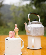 A outdoor picnic setting showing the 3 outdoor inspired wooden peg dolls and pieces from the Grapat lucky lucky boxes. Features delicate and playful hand painted designs. 