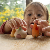 A child playing with the veg inspired wooden peg dolls from the Grapat 4th edition lucky lucky boxes showing the delicate painted detail and scale.