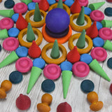 A decorative mandala pattern made from handcrafted wooden Grapat coloured mandala loose pieces 