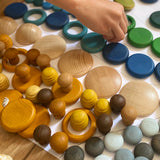 Child sorting individual Grapat wooden loose pieces in their colours