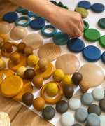 Child sorting individual Grapat wooden loose pieces in their colours