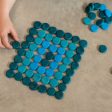 Grapat 36 Mandala Mini Coins used to create a rectangle shape by a child.