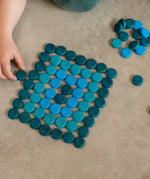 Grapat 36 Mandala Mini Coins used to create a rectangle shape by a child.