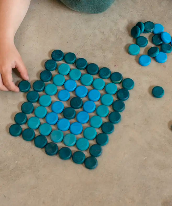 Grapat 36 Mandala Mini Coins used to create a rectangle shape by a child.