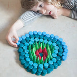 Child creating a mandala with Grapat mandala mini coins.