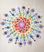 Rainbow coloured mandala created using Grapat mandala pieces.
