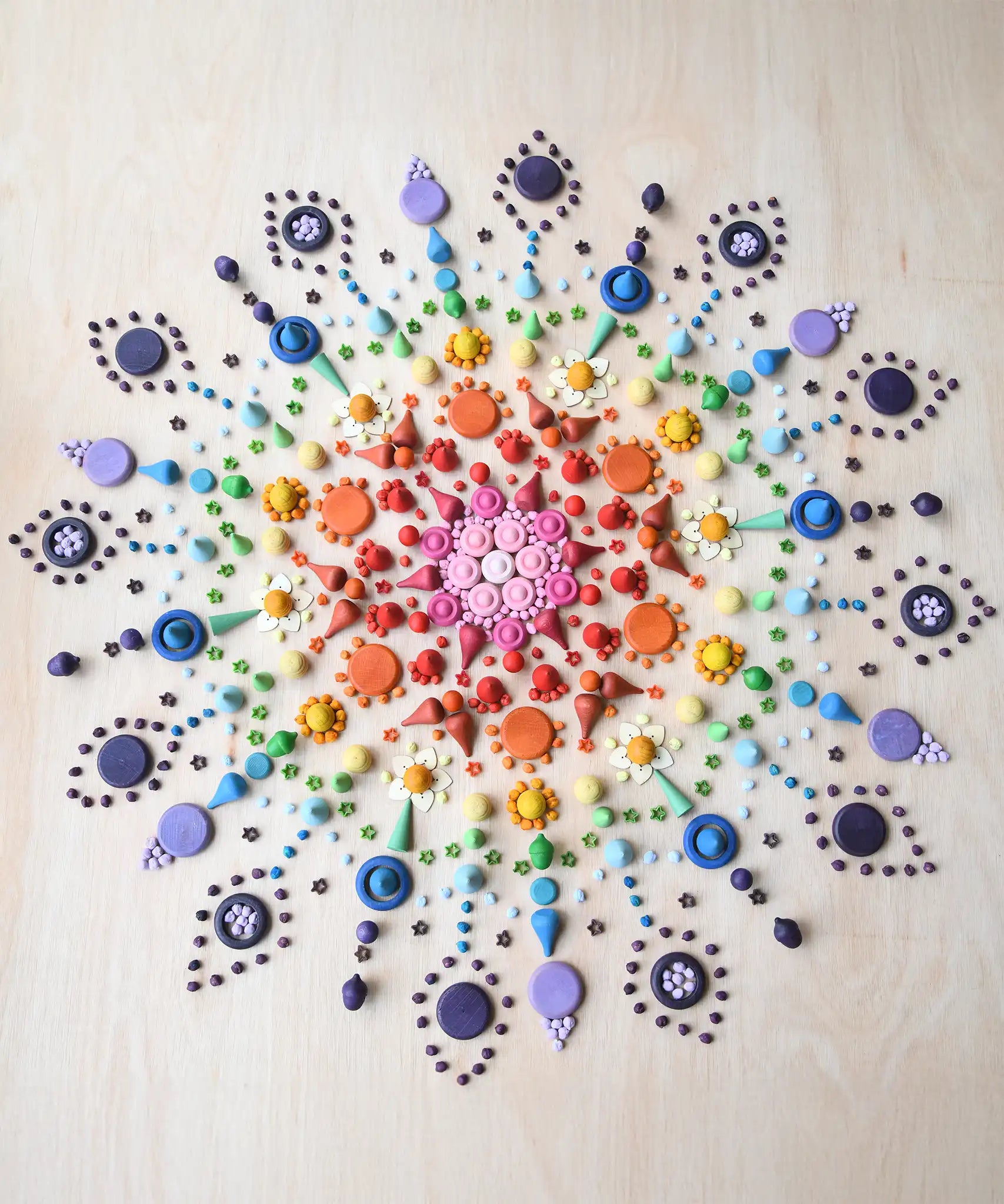 Rainbow coloured mandala created using Grapat mandala pieces.