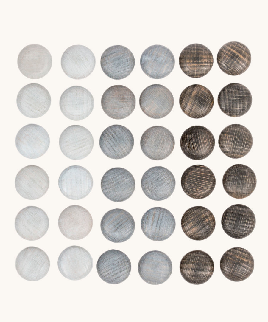 Grapat Mandala Stones. A set of 36 pebble shaped wooden mandala pieces in three shades of grey, 12 in each shade. Grapat have a wide range of wooden toys and loose parts available at Babipur. 