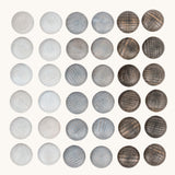 Grapat Mandala Stones. A set of 36 pebble shaped wooden mandala pieces in three shades of grey, 12 in each shade. Grapat have a wide range of wooden toys and loose parts available at Babipur. 