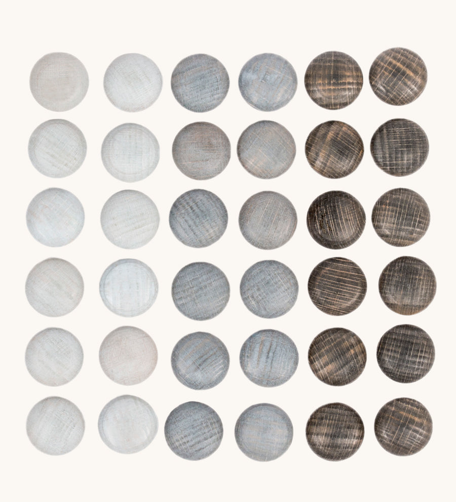 Grapat Mandala Stones. A set of 36 pebble shaped wooden mandala pieces in three shades of grey, 12 in each shade. Grapat have a wide range of wooden toys and loose parts available at Babipur. 