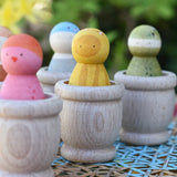Grapat mates wooden loose part cups with animal crew peg dolls placed inside.