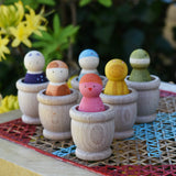 Grapat mates wooden loose part cups with animal crew peg dolls placed inside.