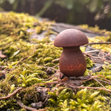A loose wooden Grapat mini mushroom piece on moss