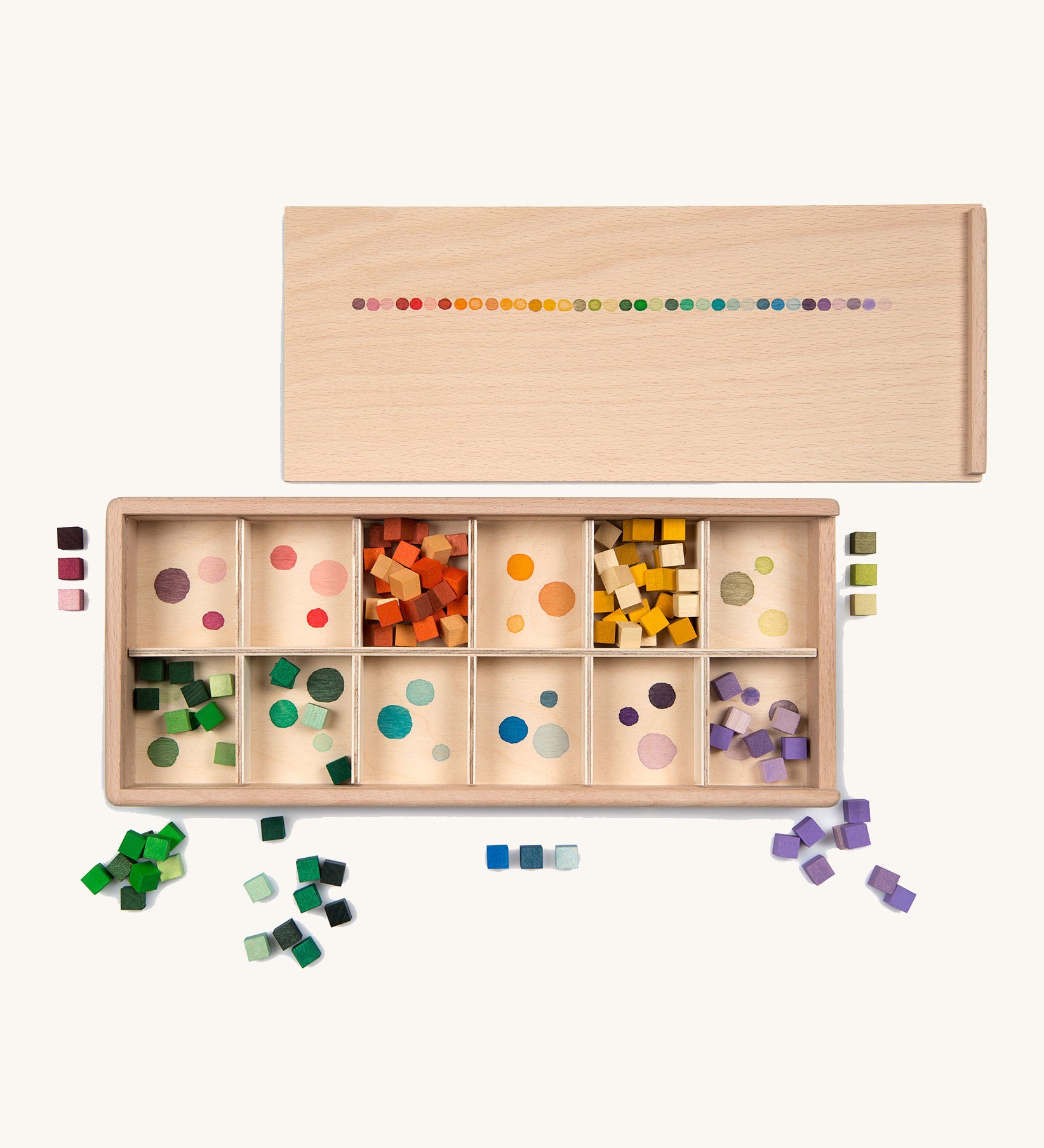 Grapat Mis and Match Wooden Sorting Box Play Set. A wooden box with 12 compartments and wooden cubes in rainbow colours.