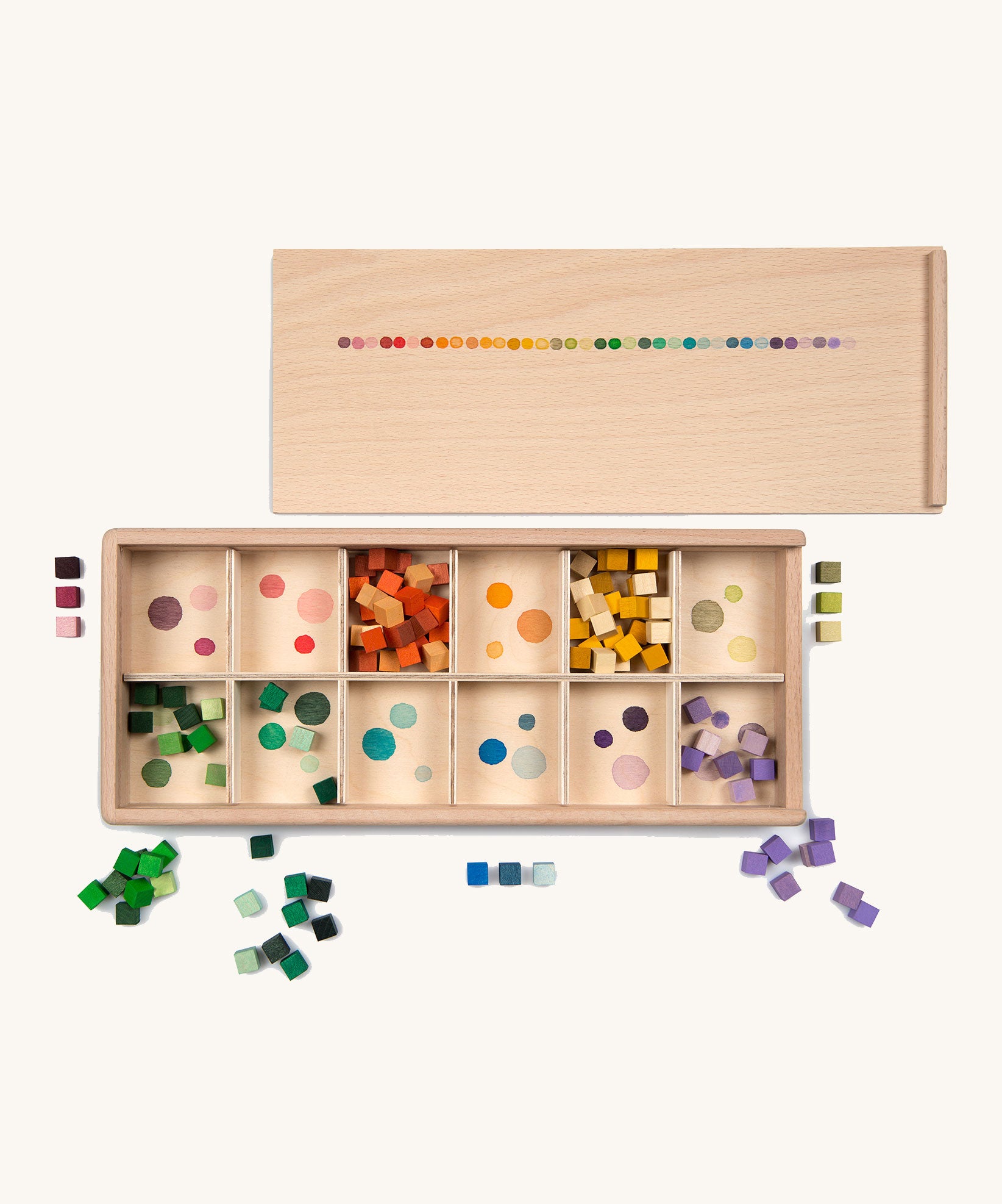 Grapat Mis and Match Wooden Sorting Box Play Set. A wooden box with 12 compartments and wooden cubes in rainbow colours.