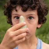A child holding the green wooden monster peg doll from the Grapat 4th edition lucky lucky boxes showing the painted detail and scale