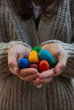 Grapat rainbow eggs held in hand.