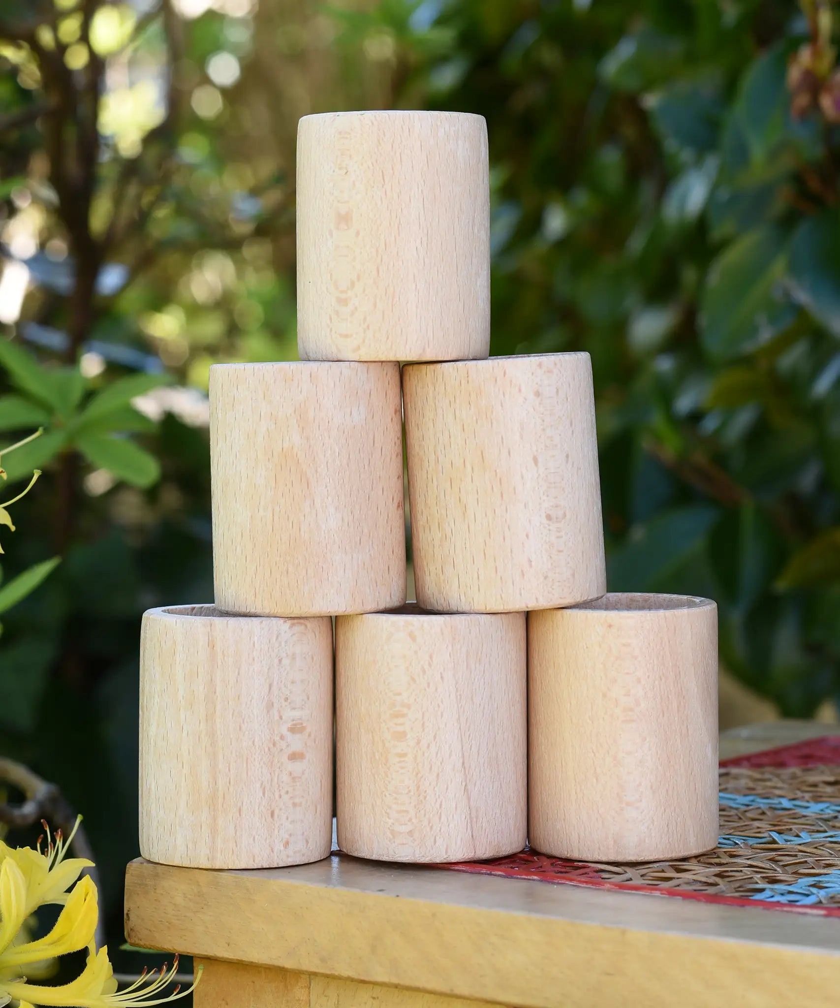 Grapat natural cups stacked up on a stool outdoors. 