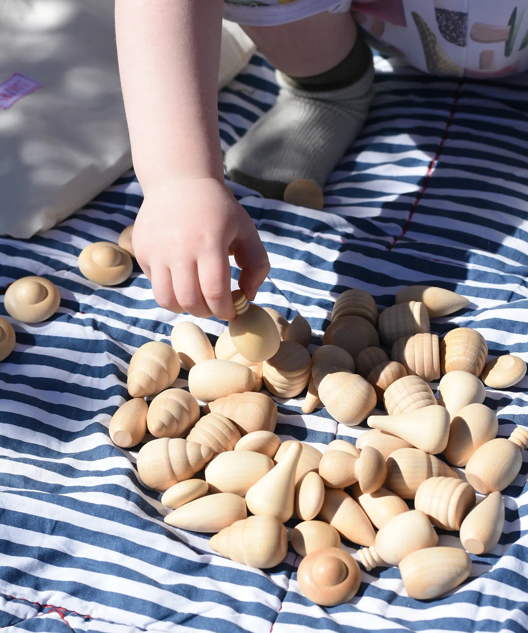 Grapat natural mandala pieces paced on a blanket outdoors. 