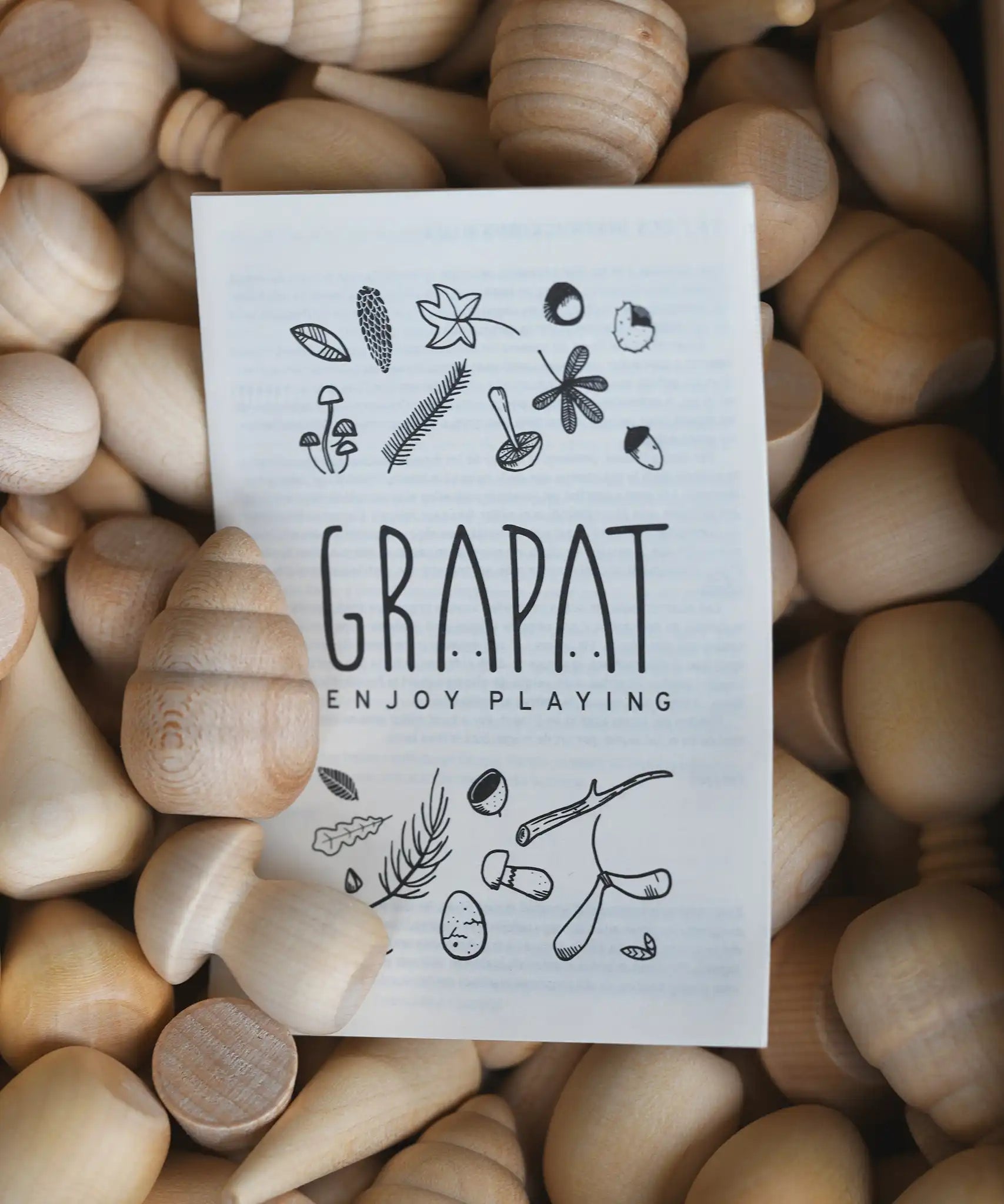 Grapat Natural Wood Mandala shown in the box with a information leaflet on top.