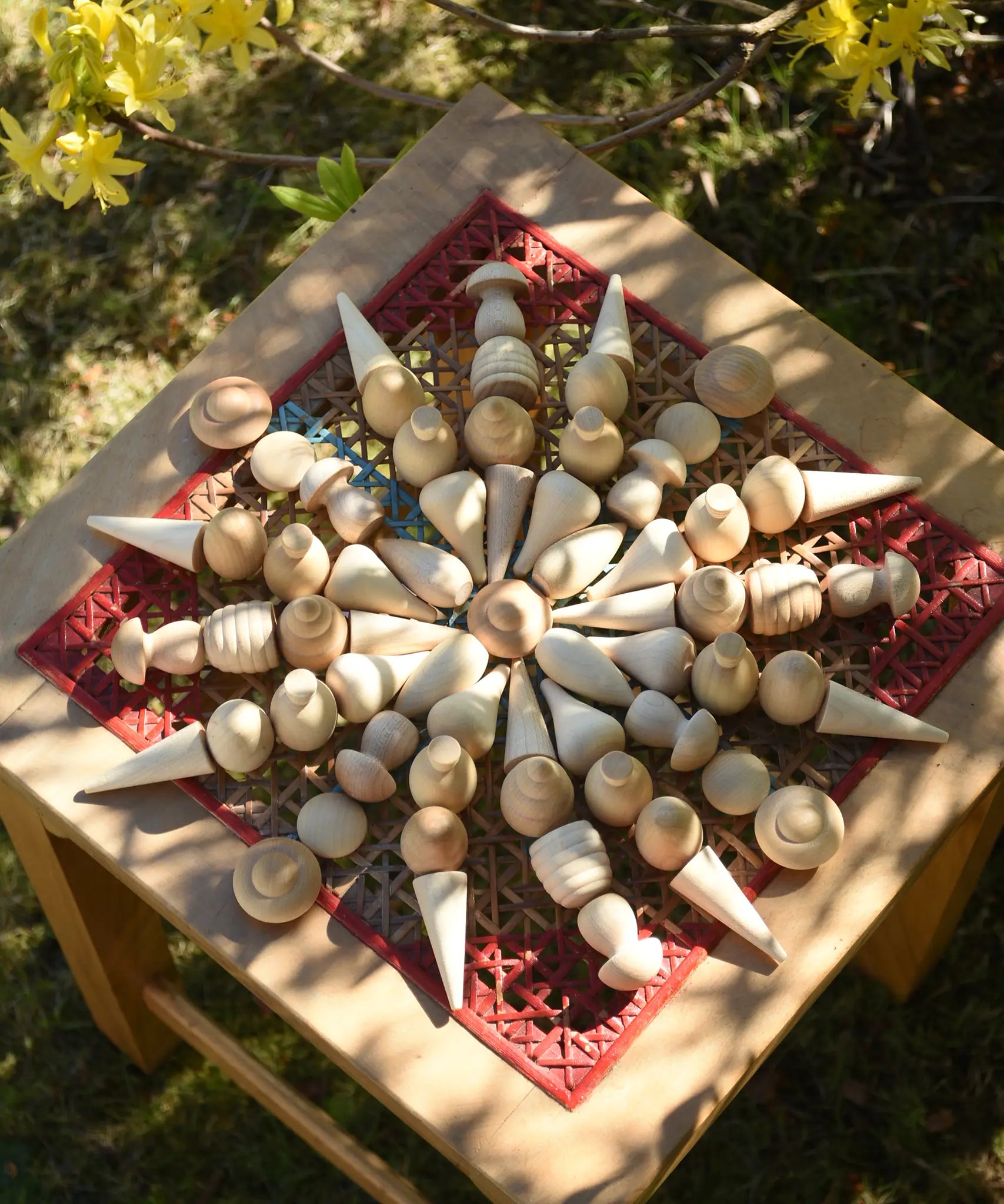 Mandala created using Grapat natural mandala pieceson a stoll outdoors.