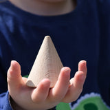 Grapat natural wooden cone in a child's hand. 