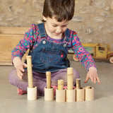 Child sorting bamboo sticks in the Grapat handcrafted unpainted wooden cups with matching lids