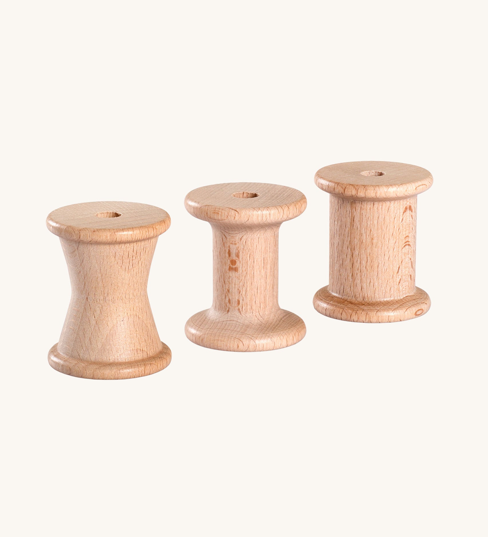 Grapat Loose Parts 3 Natural Wooden Spools. Each spool has a different size or shape of column. These spools are a part of a wide range of loose parts and wooden toys by Grapat available here at Babipur. 