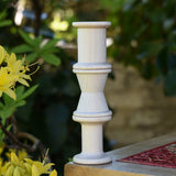 Grapat loose parts 3 natural wooden spools stacked on a stool. 