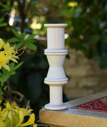 Grapat loose parts 3 natural wooden spools stacked on a stool. 