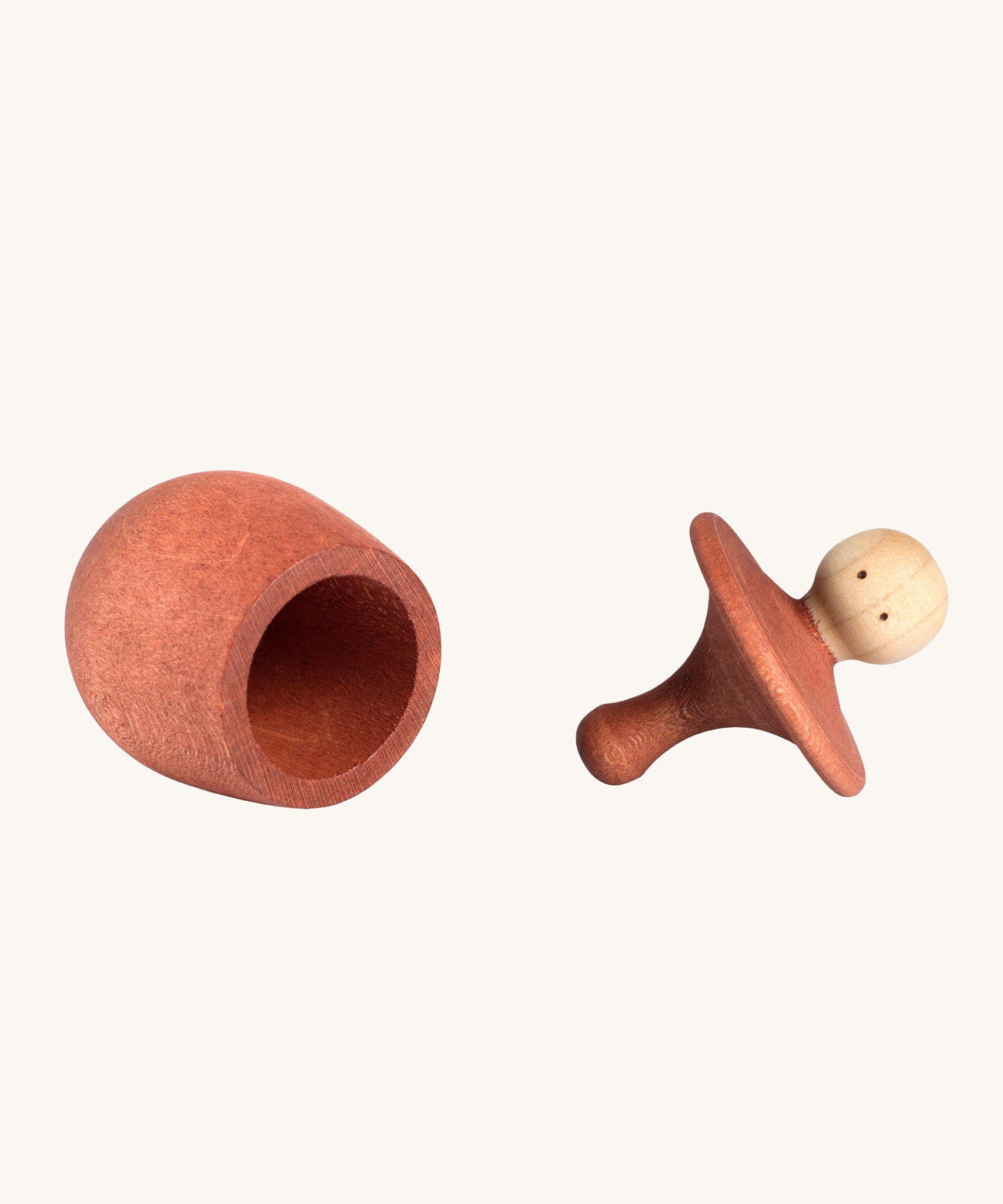 Grapat orange Little Things. A wooden top with eyes drawn on and an orange coloured pot to match. Grapat have a wide range of wooden toys and loose parts available at Babipur. 