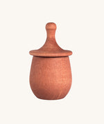 Grapat orange Little Things. A wooden top with eyes drawn on and an orange coloured pot to match. Grapat have a wide range of wooden toys and loose parts available at Babipur. 