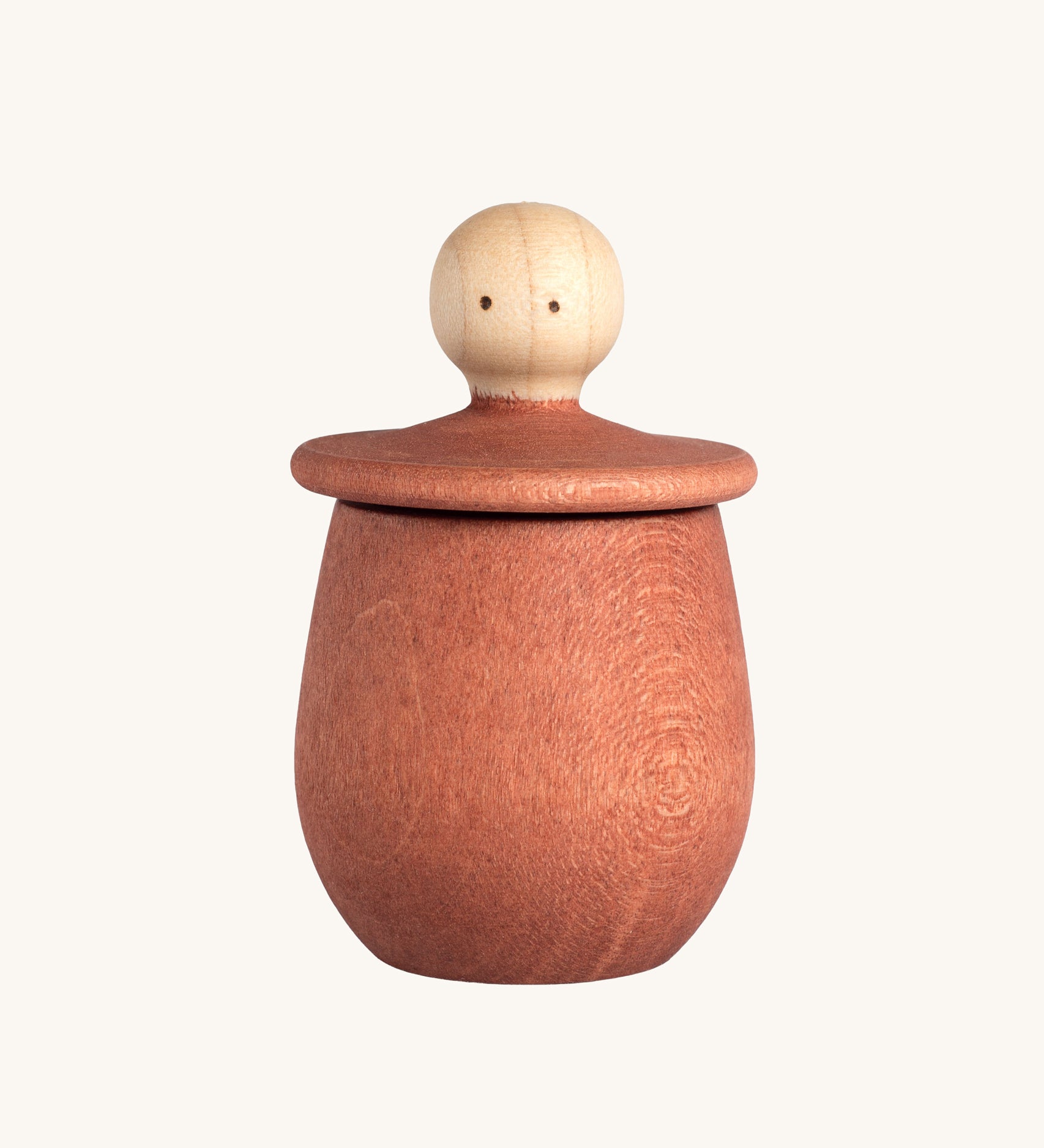 Grapat orange Little Things. A wooden top with eyes drawn on and an orange coloured pot to match. Grapat have a wide range of wooden toys and loose parts available at Babipur. 