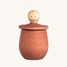 Grapat orange Little Things. A wooden top with eyes drawn on and an orange coloured pot to match. Grapat have a wide range of wooden toys and loose parts available at Babipur. 