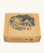 The box that the The Grapat Ostheimer Limited Edition Hello Winter wooden toy set comes in available at Babipur. Features 5 hand cut and hand painted figures and pieces including a peg doll, small decorative bowl, owl and 2 green coloured snowdrop mandala pieces. 