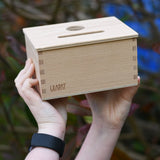 Grapat object permanence box shown in a child's hands.