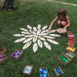 A child playing with the Grapat petals wooden platform.  A set of 24 wooden petals. These platform bases are perfect for use with Grapat mandala pieces. These wooden petals are part of a huge range of open ended wooden toys from Grapat available here at Babipur.