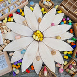 The Grapat petals wooden platforms used to create a large flower with yellow coloured mandala pieces placed in the middle. These are a set of 24 wooden petals. These wooden petals are part of a huge range of open ended wooden toys from Grapat available here at Babipur.