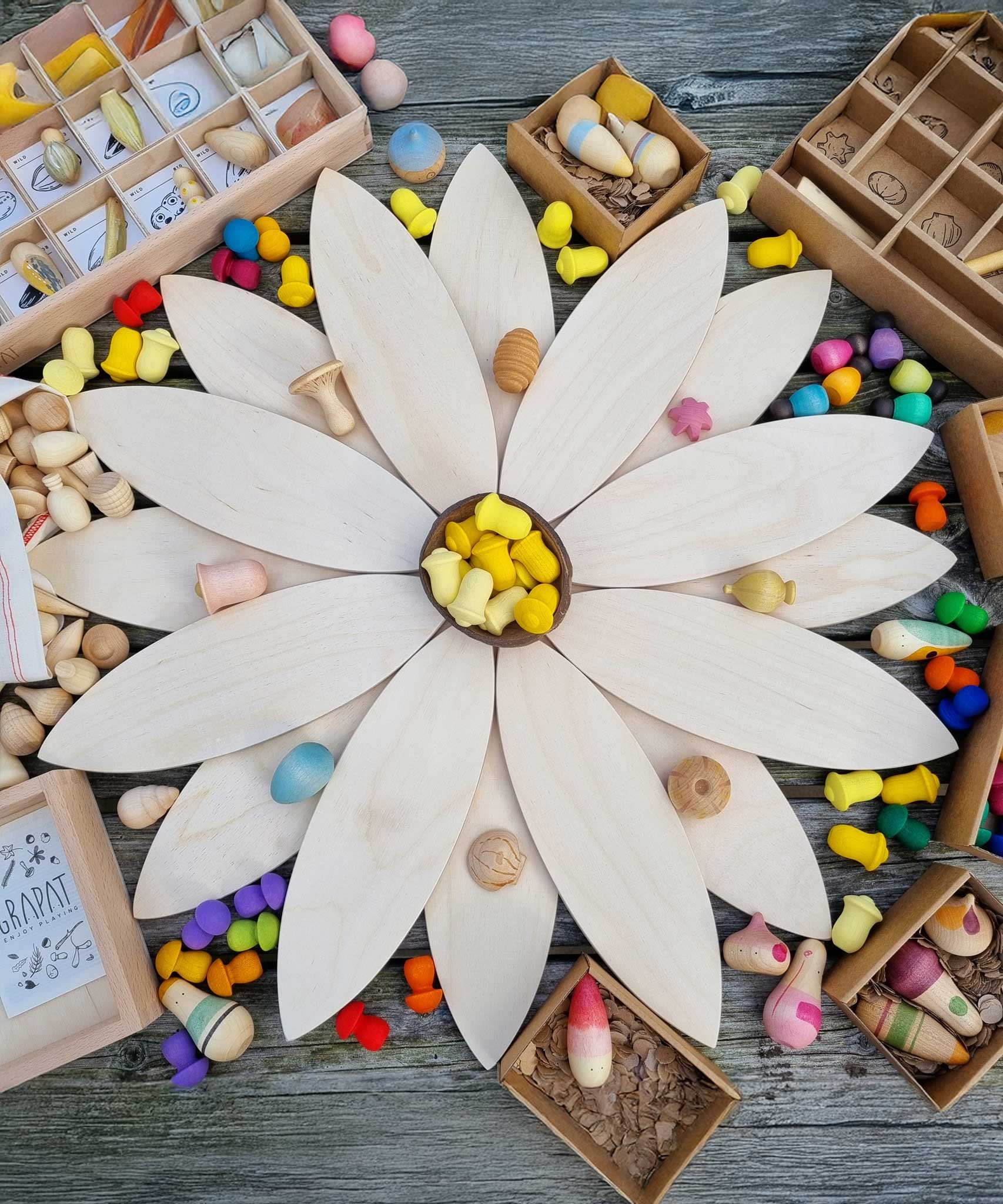 The Grapat petals wooden platforms used to create a large flower with yellow coloured mandala pieces placed in the middle. These are a set of 24 wooden petals. These wooden petals are part of a huge range of open ended wooden toys from Grapat available here at Babipur.