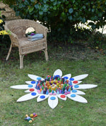 Grapat petal platform pieces laid out on grass to create a mandala with Grapat lose parts.